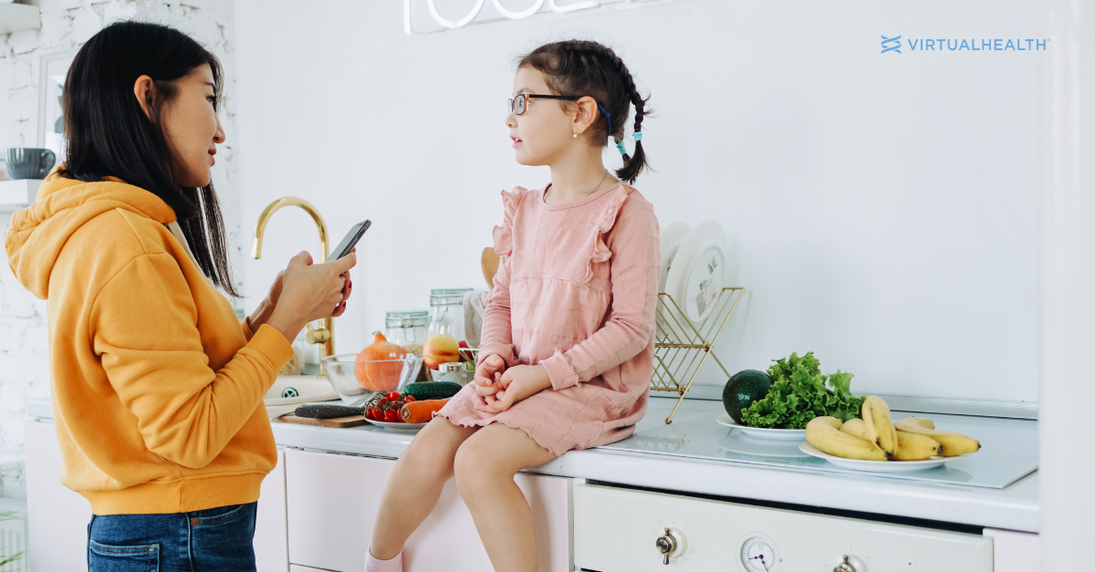 woman talking with young girl who is sitting on a counter
