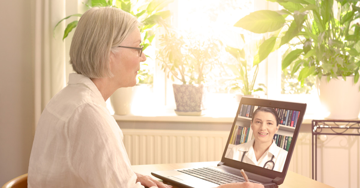 woman having telehealth appointment with provider on laptop